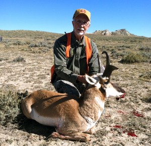 Hunting guide posing with his pronghorn antelope in the sagebrush
