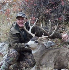 Hunter with his mule deer he harvested on a hunt with SNS Outfitter & Guides