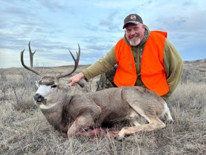 male hunter with trophy mule deer from a guided hunt with SNS Outfitter and guides in Montana 