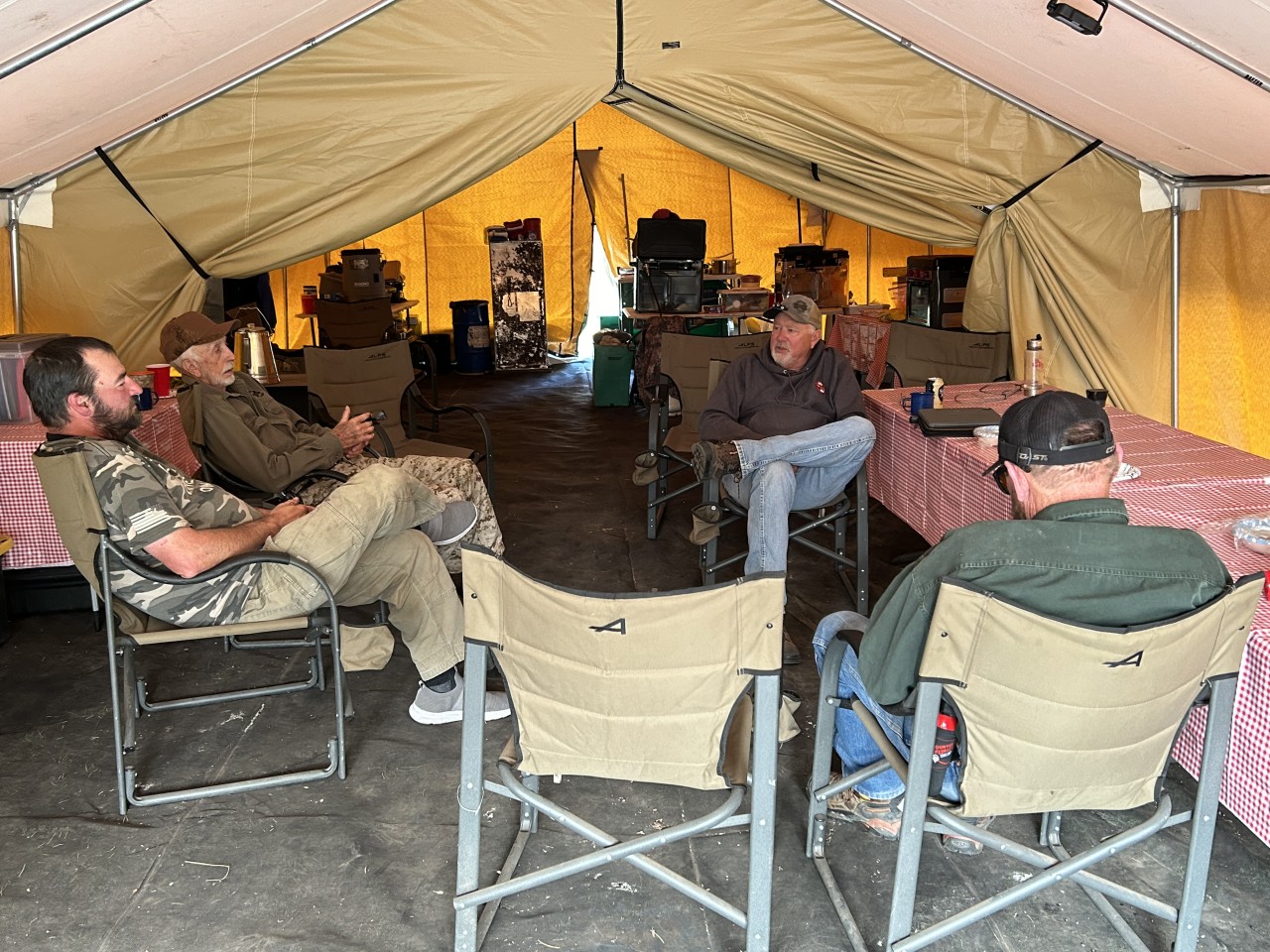 People enjoying the cook tent at hunting camp.