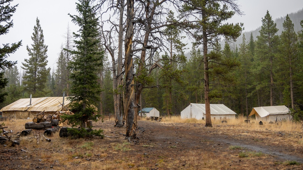 wilderness elk hunting camp is draped in fog and rain but still a cozy retreat for wyoming hunters