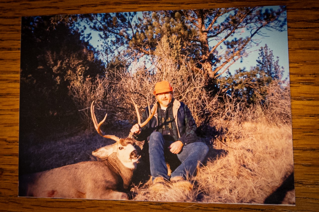hunter poses with a large mule deer buck in Wyoming