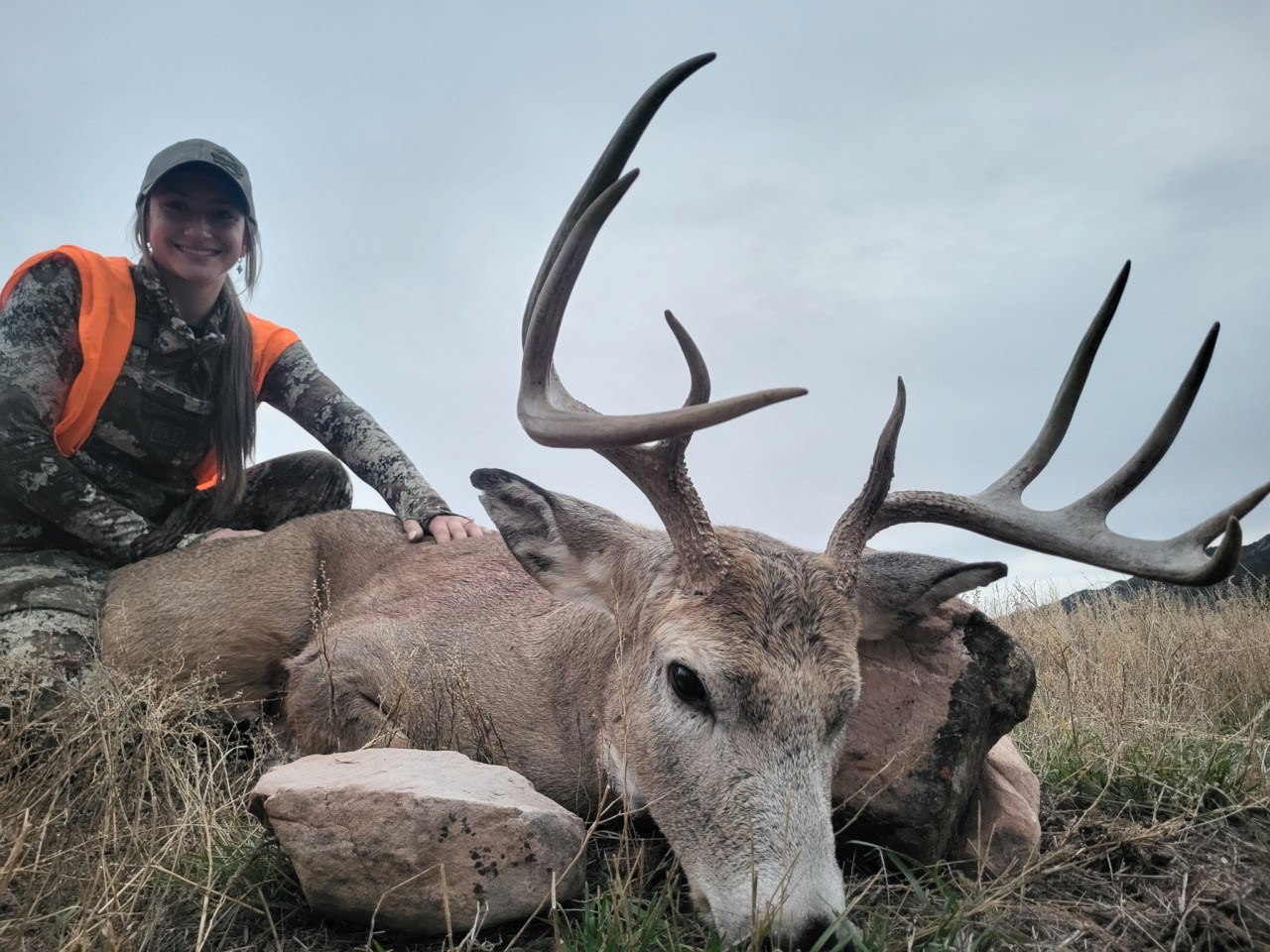 hunter poses with a large whitetail buck deer in wyoming